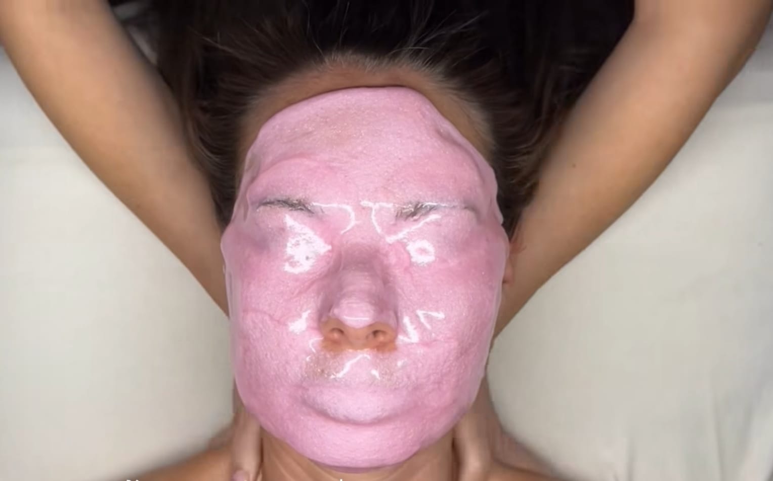 Woman receiving facial care at home