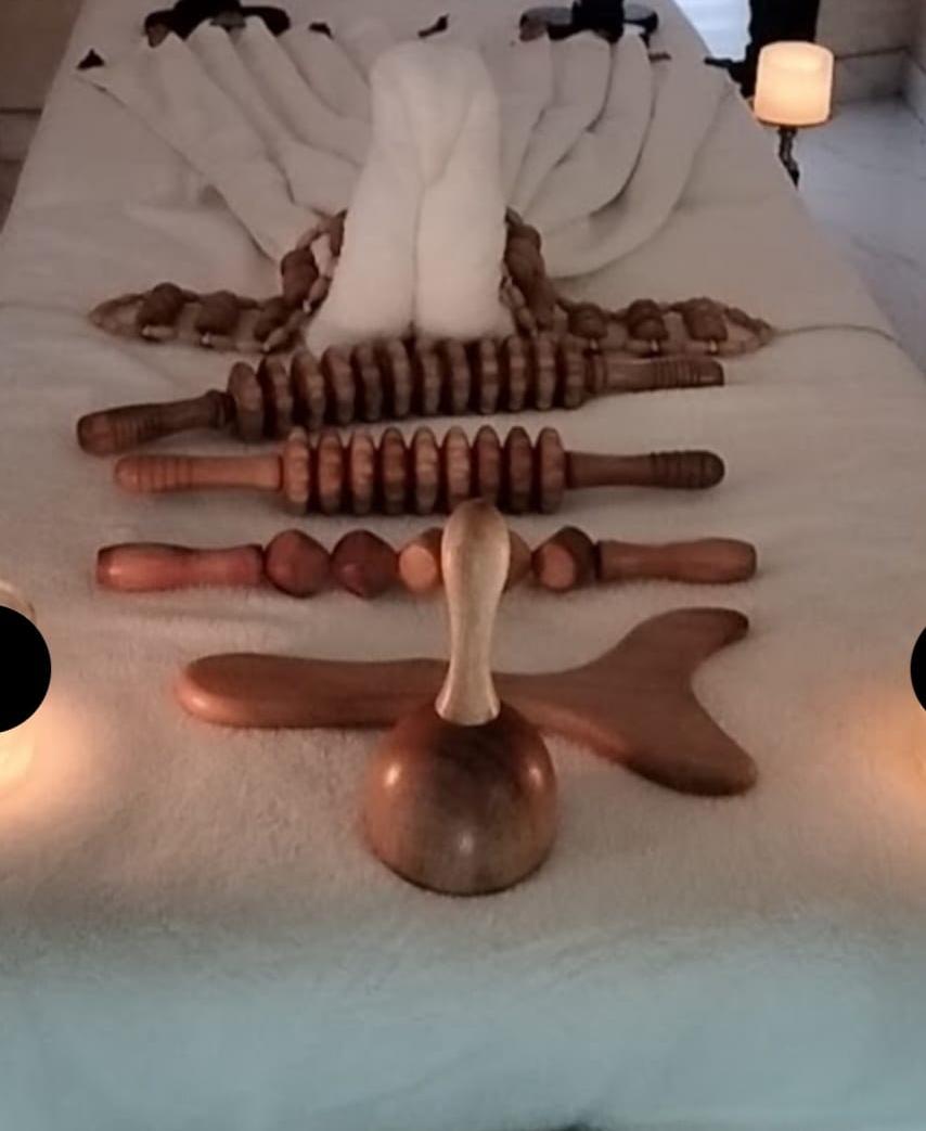 Wooden massage tools arranged on a treatment bed